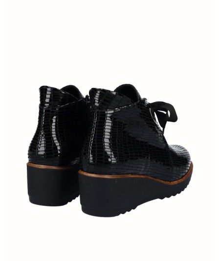 Black embossed leather wedge ankle boots